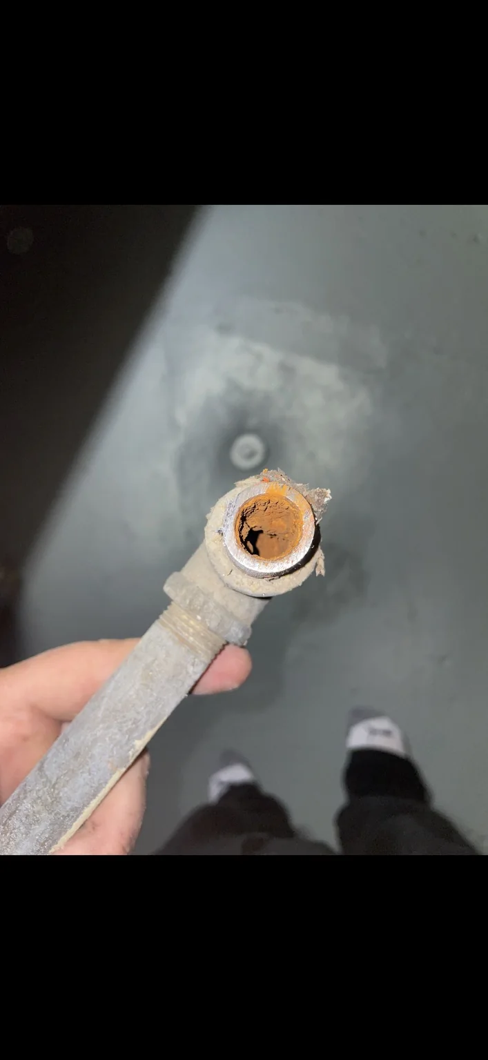 Corroded galvanized water line removed during an inspection-related plumbing repair
