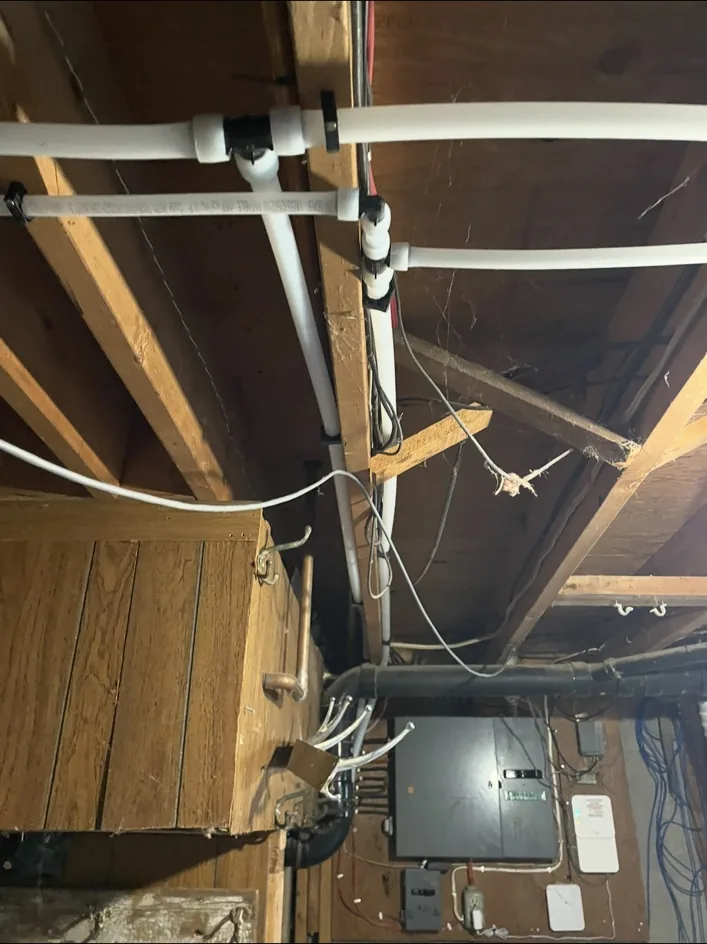 PEX-A plumbing lines neatly installed in basement ceiling